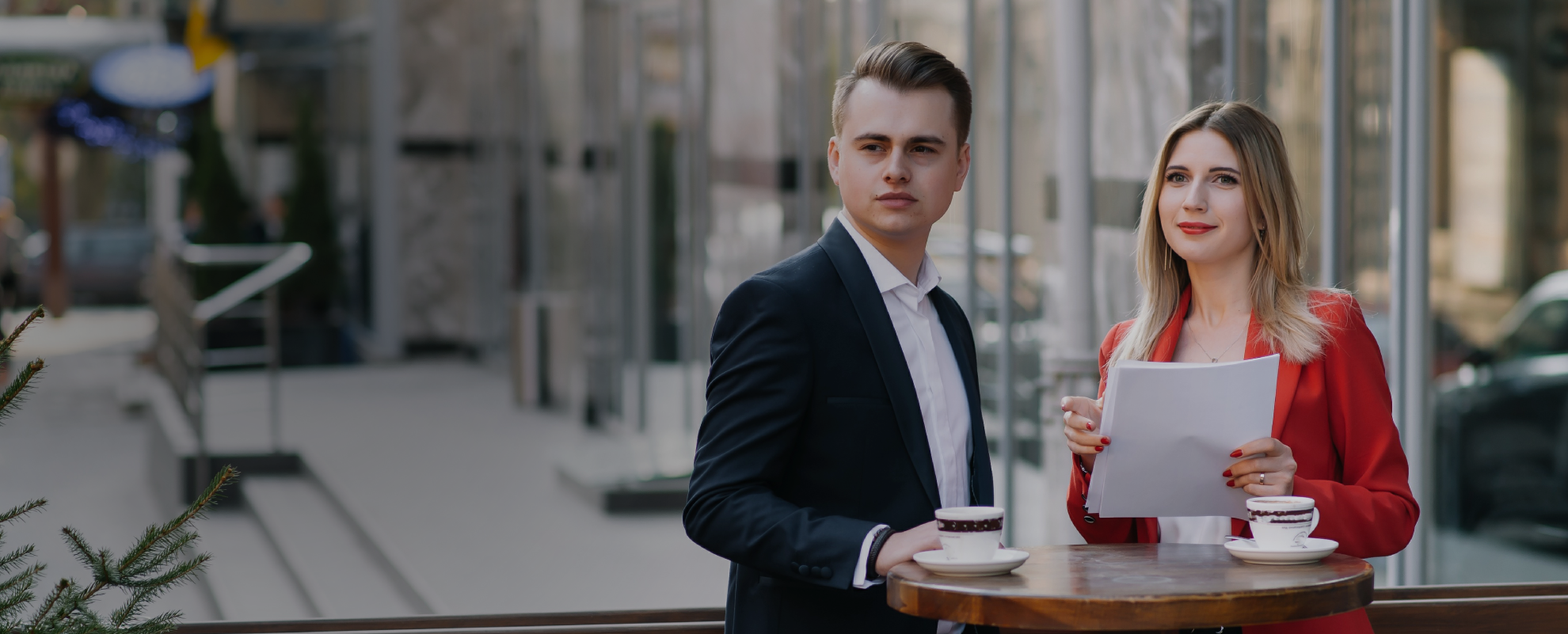 “Weblook web design Sri Lanka - Two individuals engaged in a meeting, possibly discussing web design strategies over coffee.”