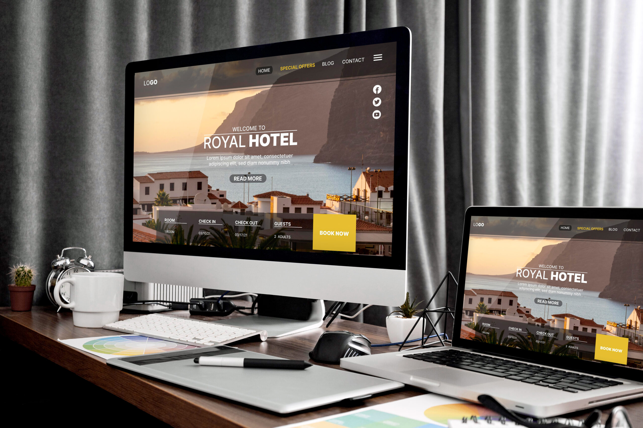 A desktop computer and a laptop displaying a hotel website with a booking interface, showcasing Weblook International's creative web design services in Sri Lanka.