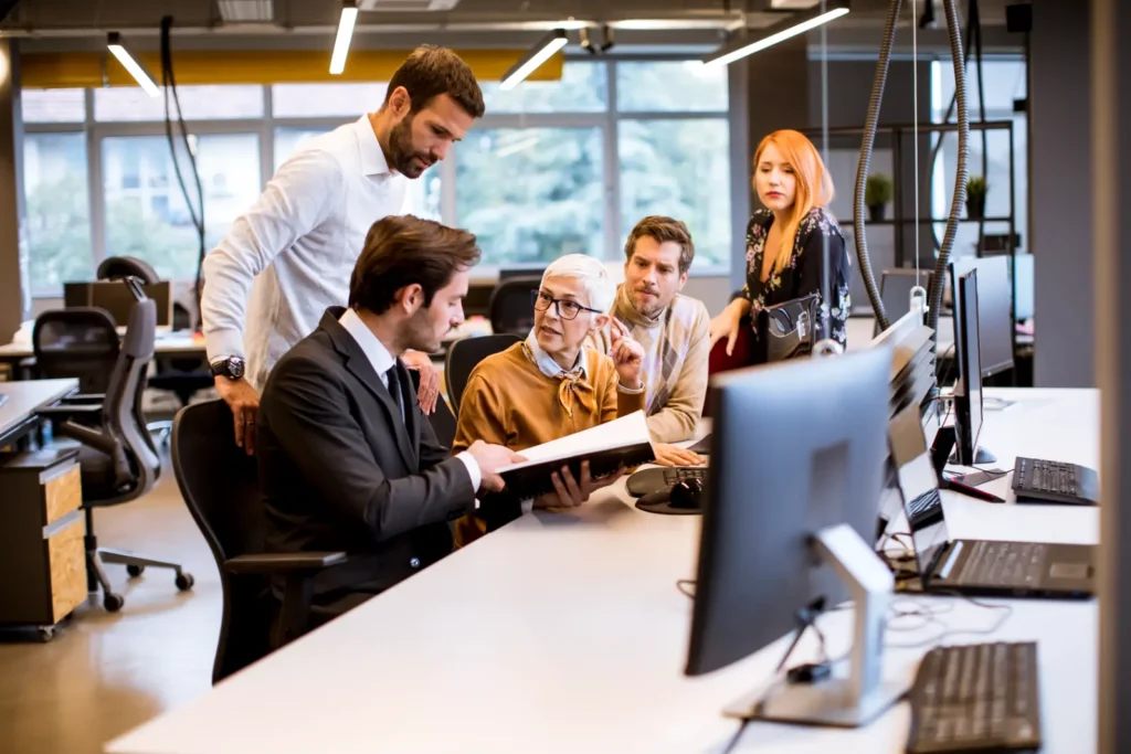 senior businesswoman working together with young business people modern office | Web Design for E-Commerce Business Weblook International | Software Development | Digital Marketing | Web Designing | Web Design for E-Commerce Business